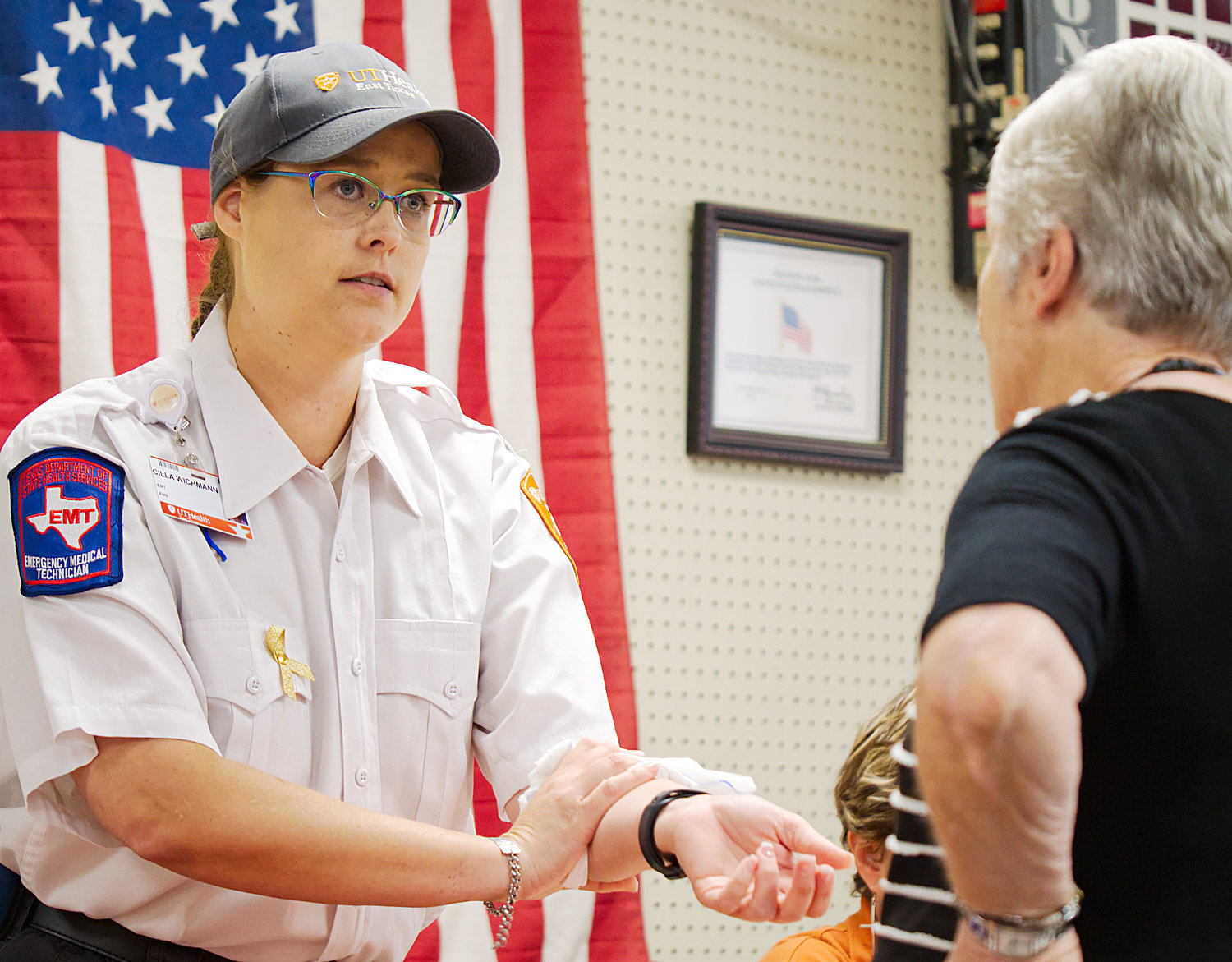 Cilla Wichmann, with UT Health EMS, demonstrates one of the Stop the Bleed methods for Elaine Douglas during the annual health fair last Thursday at the Forever Young senior center in Quitman.